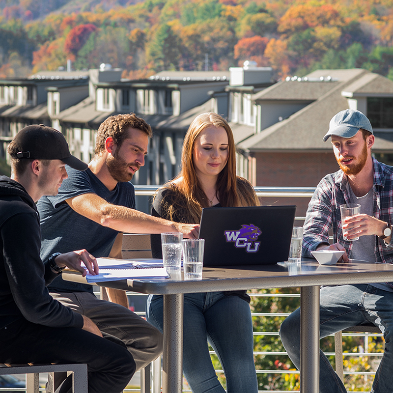 Students Studying on a roof top patio at Brown Hall