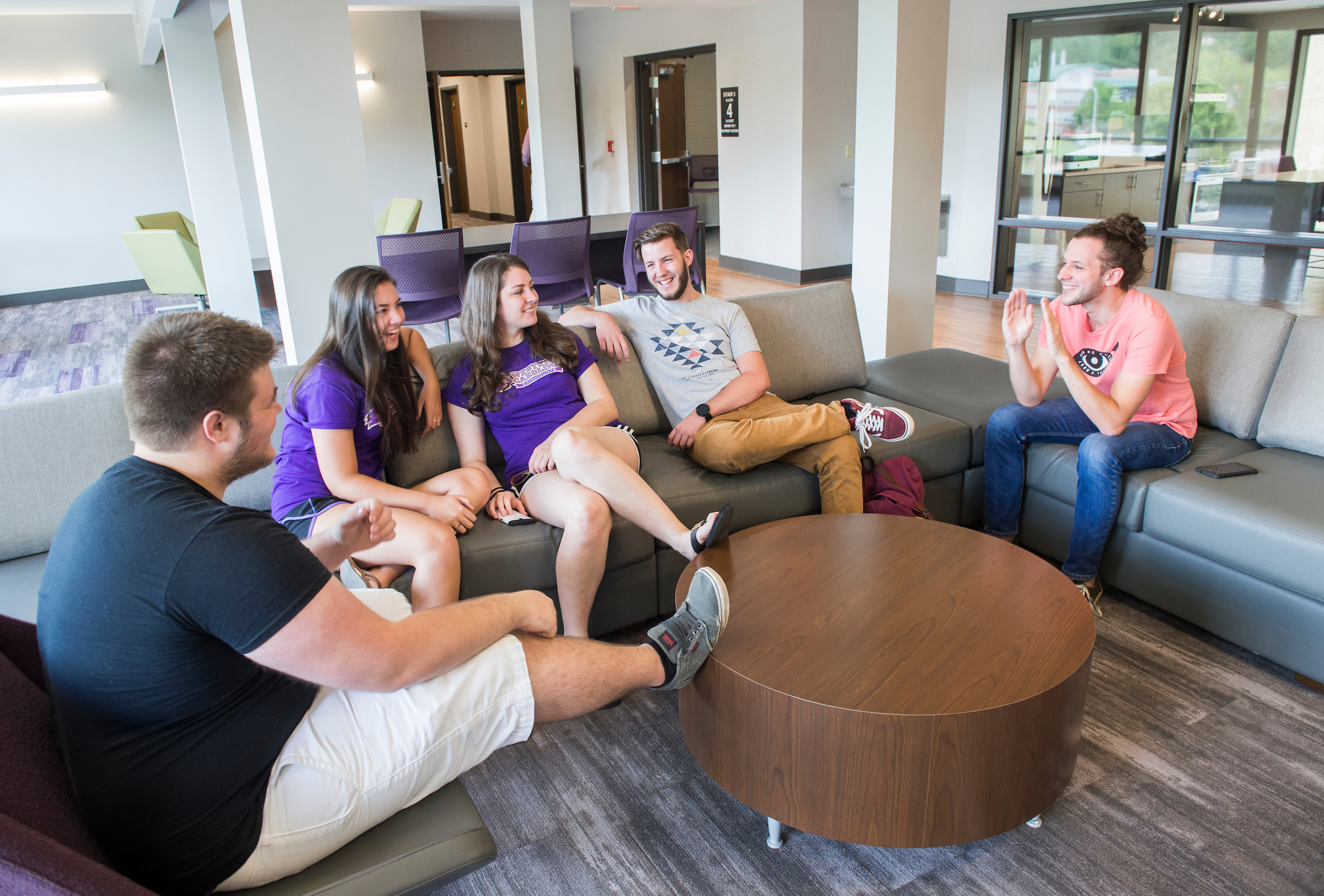 Students spending time, hanging out together in the common area of a Residence Hall
