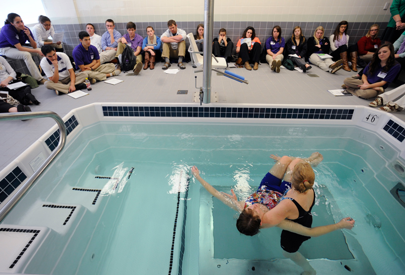 Class of students learning at the therapy pool