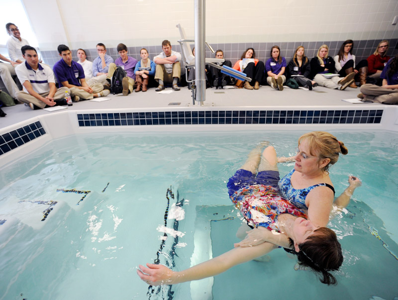 Recreational therapy students learning about Aquatic Therapy at a pool