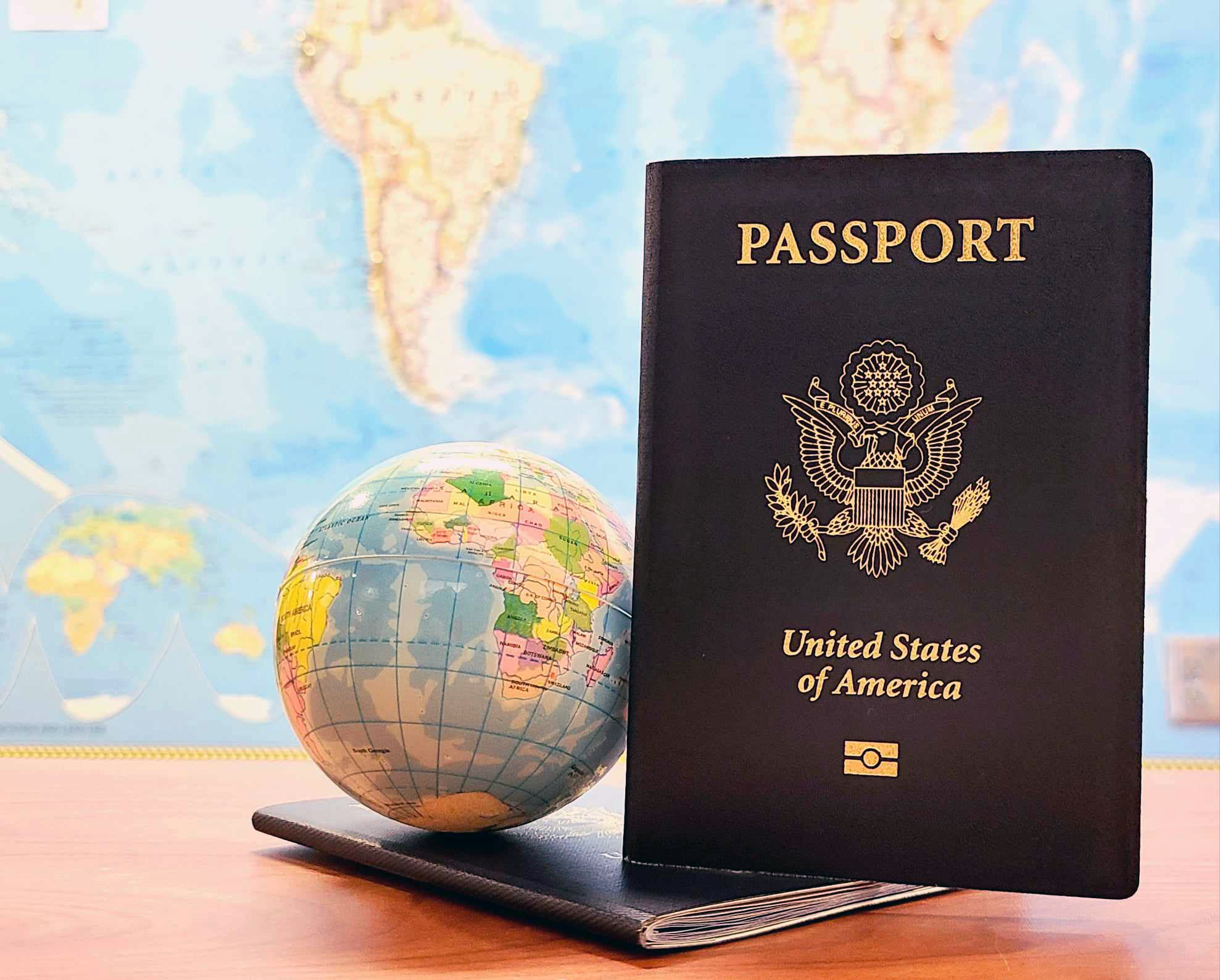 image of two USA passports and a globe