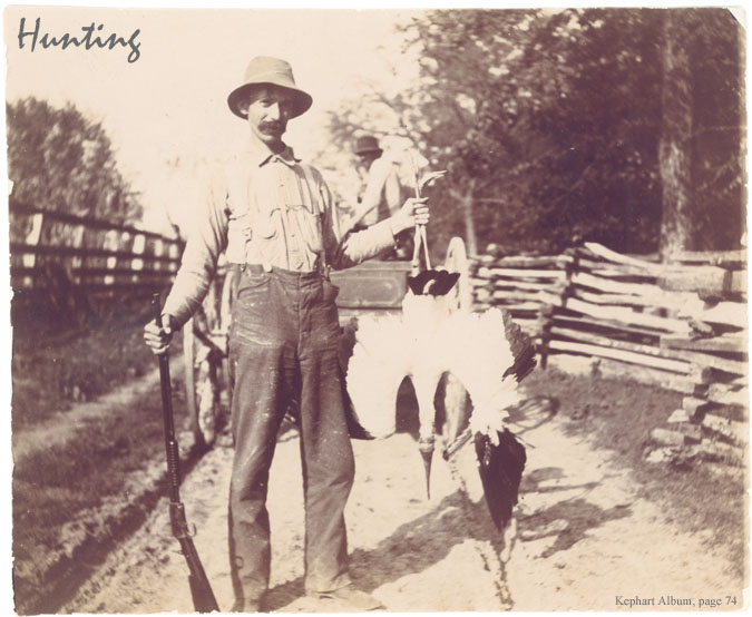 Hunting photograph showing a man holding a dead bird.