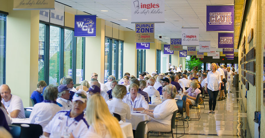 People sitting at tables in the Purple Zone
