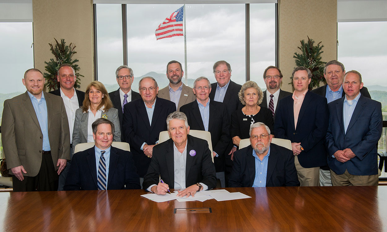 Members of the board of directors of Entegra Bank participate in a signing ceremony marking the creation of the Entegra Bank Endowed Scholarship Fund.