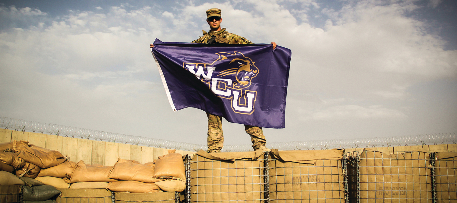 WCU Military student holding WCU Flag