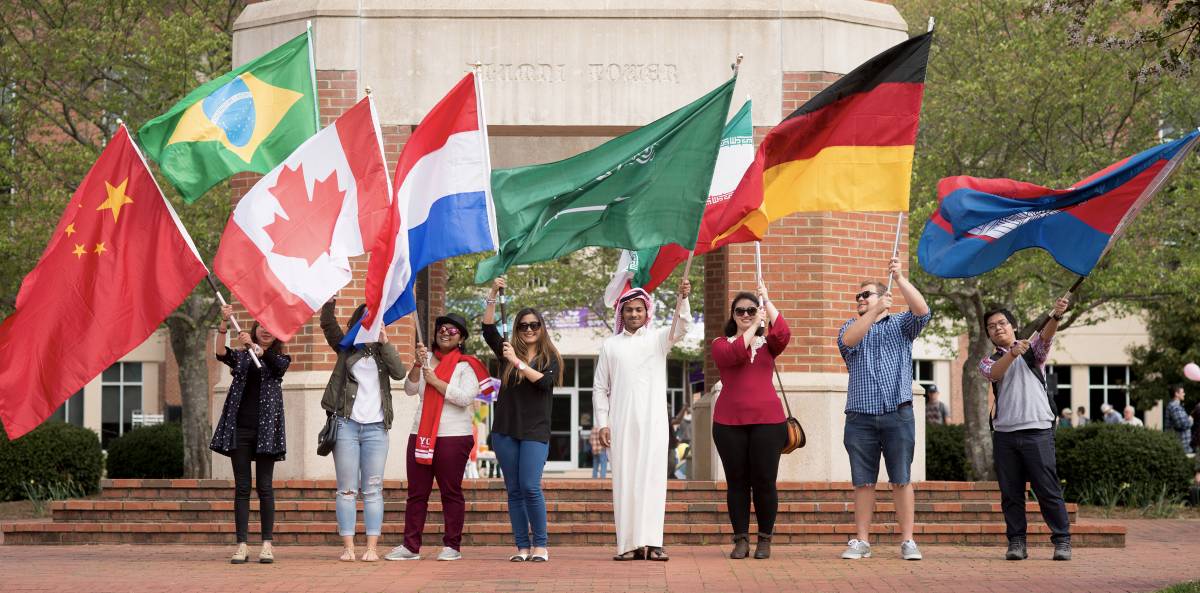 students carrying international flags