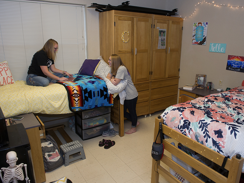 Two female students in their room in Norton Hall.