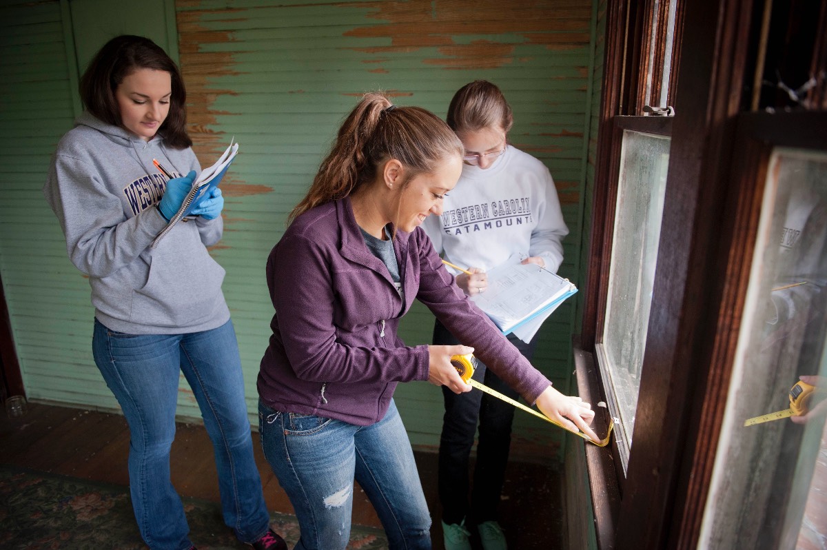 Interior Design students taking measurements inside historic building