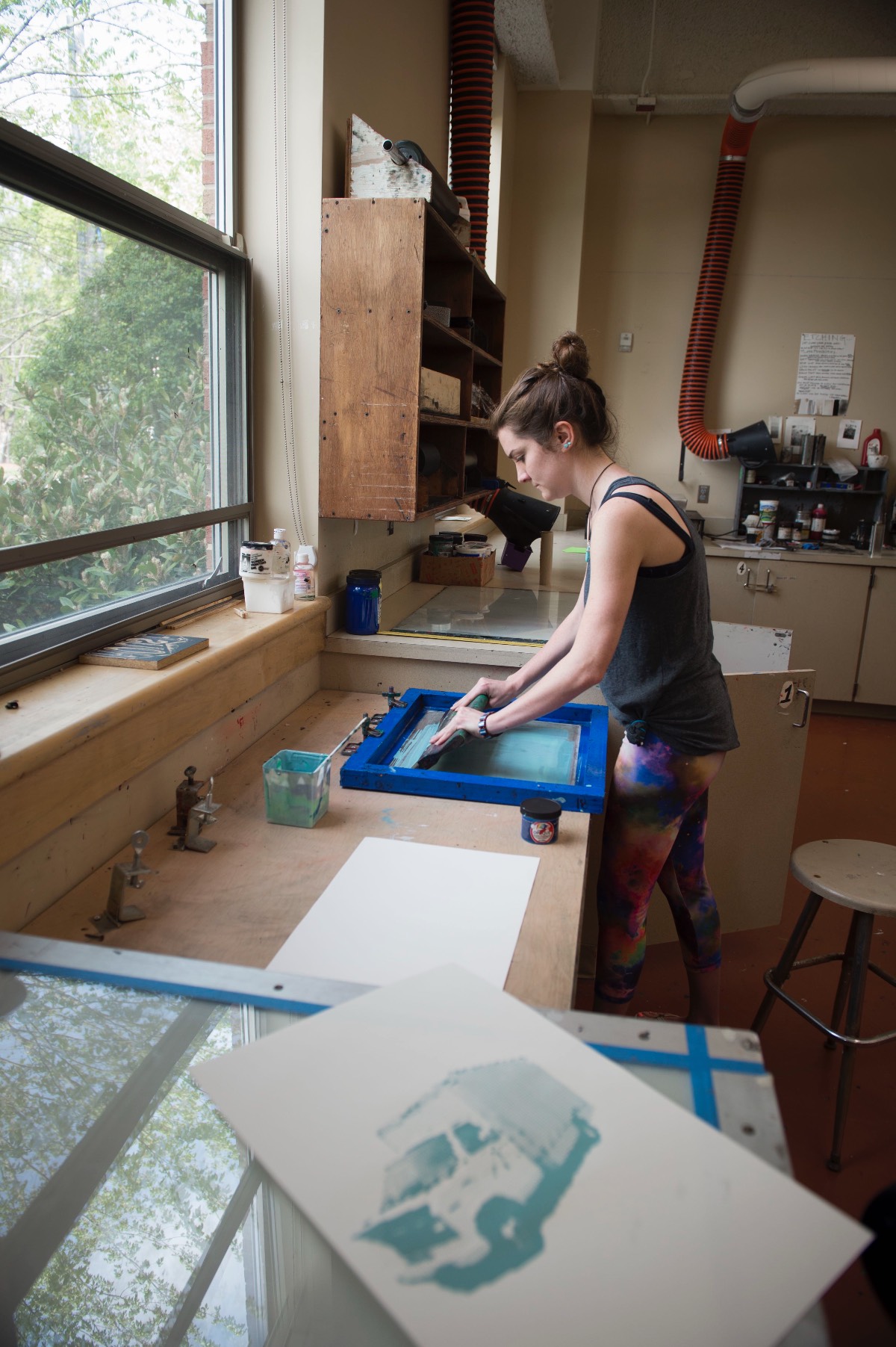Printmaking student rinsing silk screen