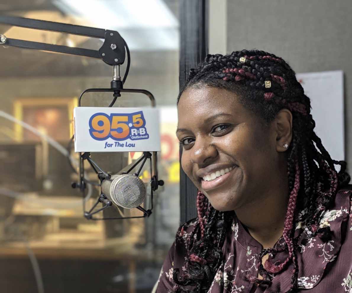 Nicole Brewer, black woman speaking into a radio microphone