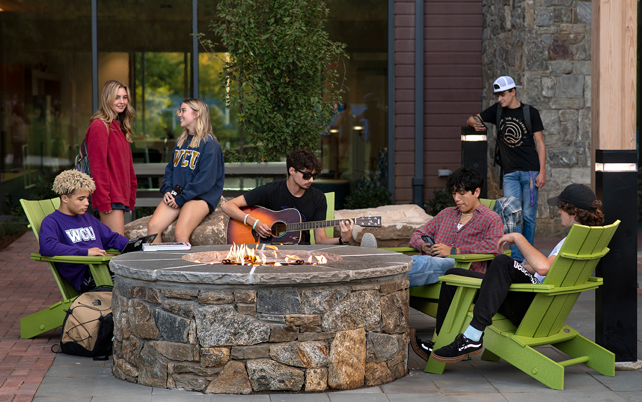 students sitting around a firepit