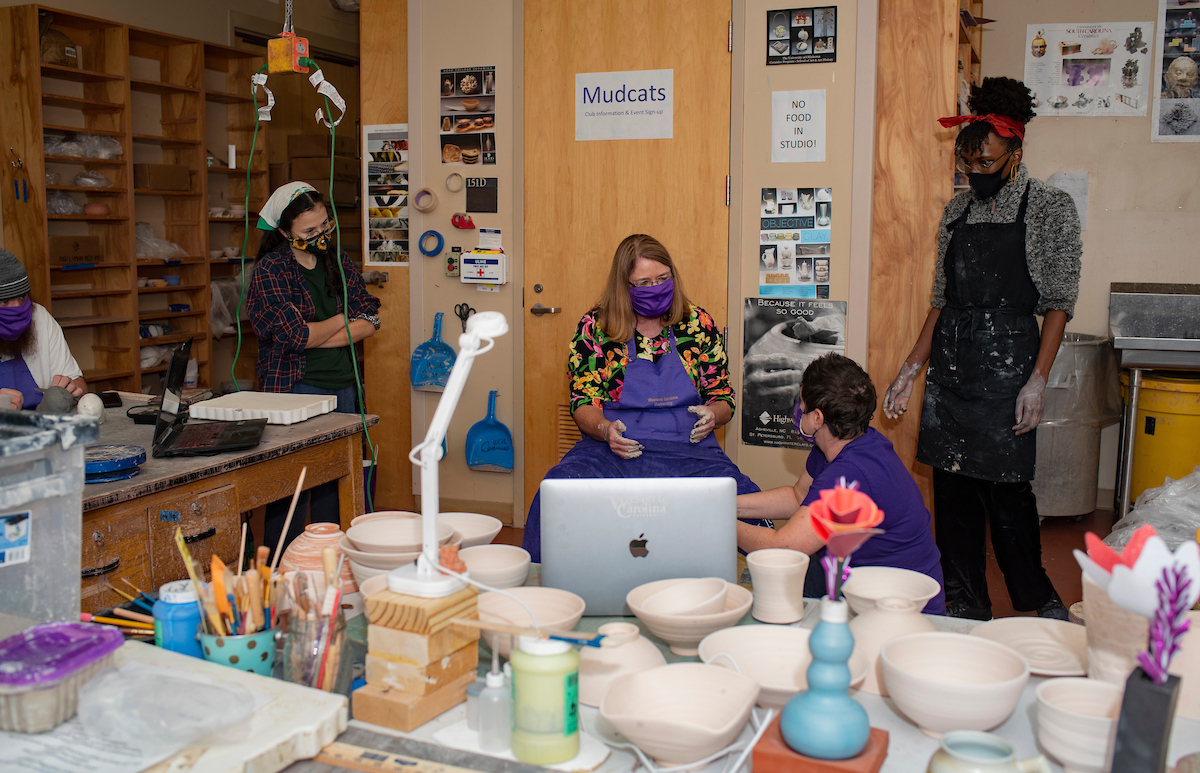 Chancellor Kelli R. Brown in a ceramics class with students