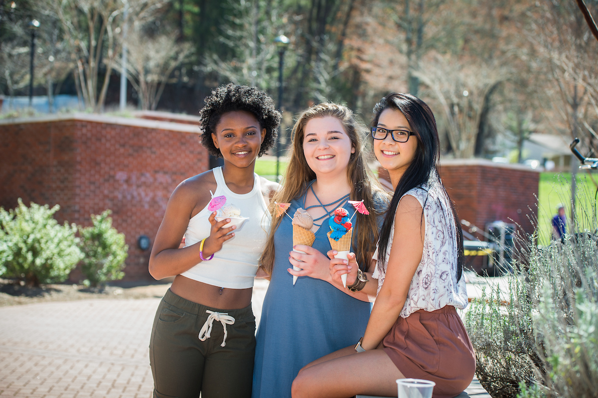 three students smiling at camera