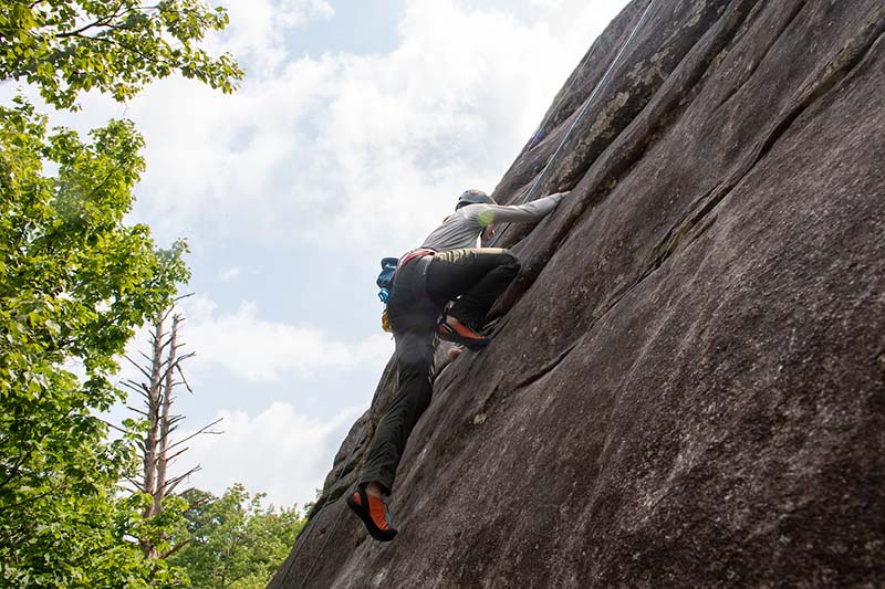 student rock climbing