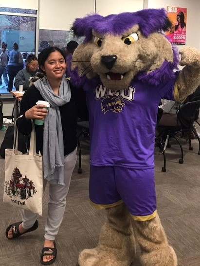 WCU student with PAWS in the Intercultural Affairs lounge