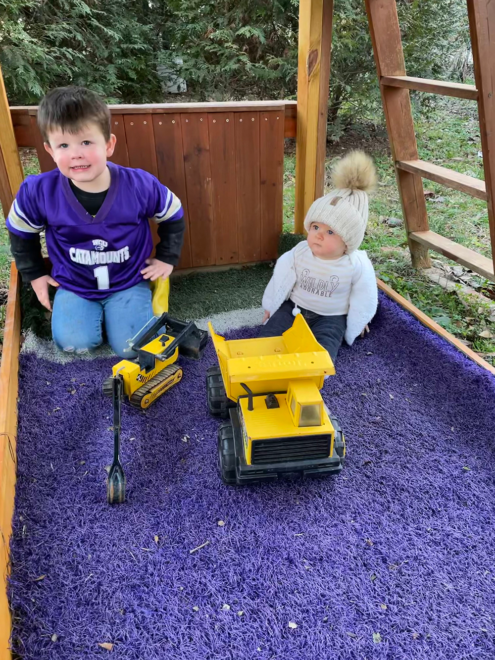 Moller's children playing in a purple sandbox