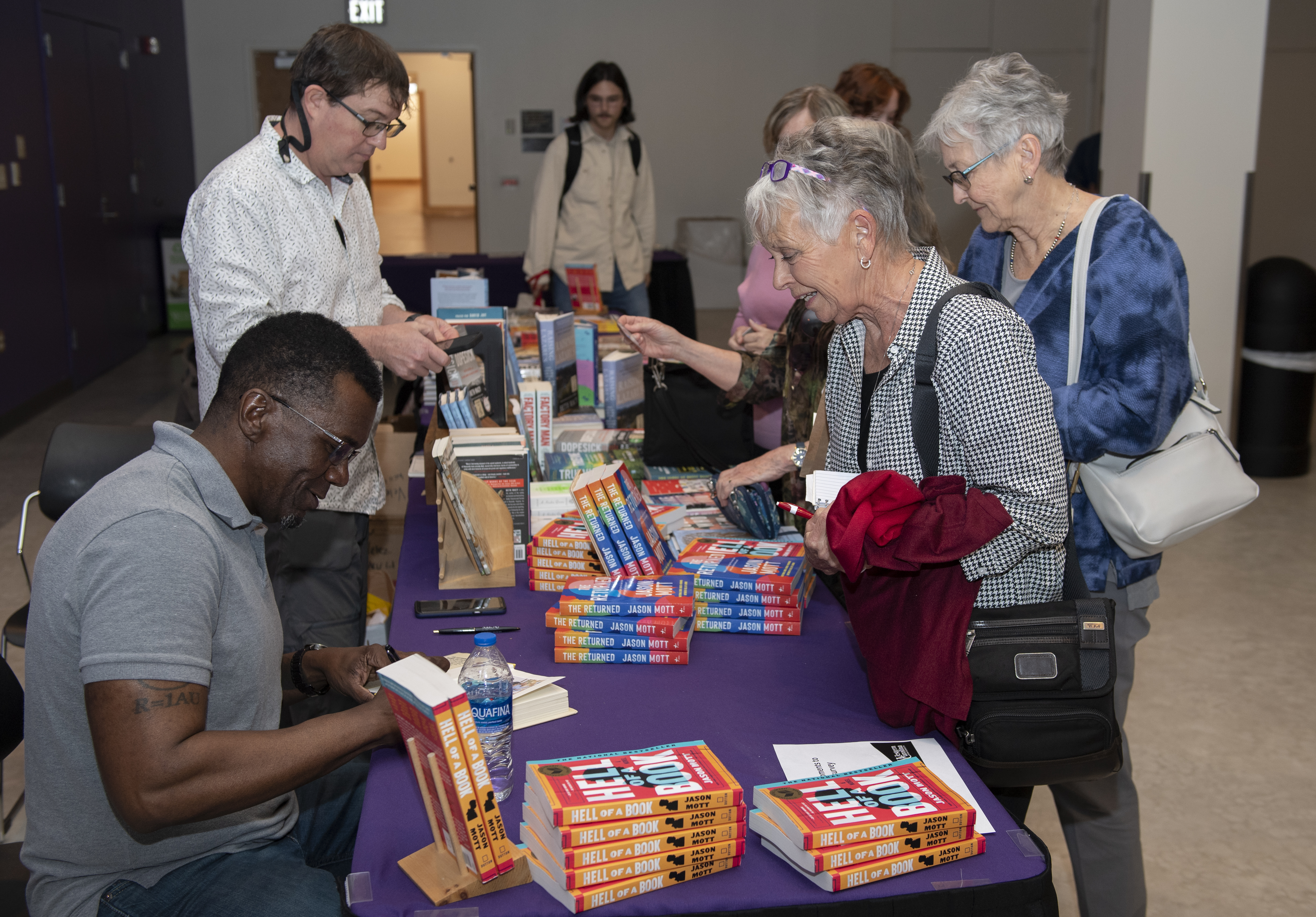 Jason Mott signing copies of his novel Hell of a Book