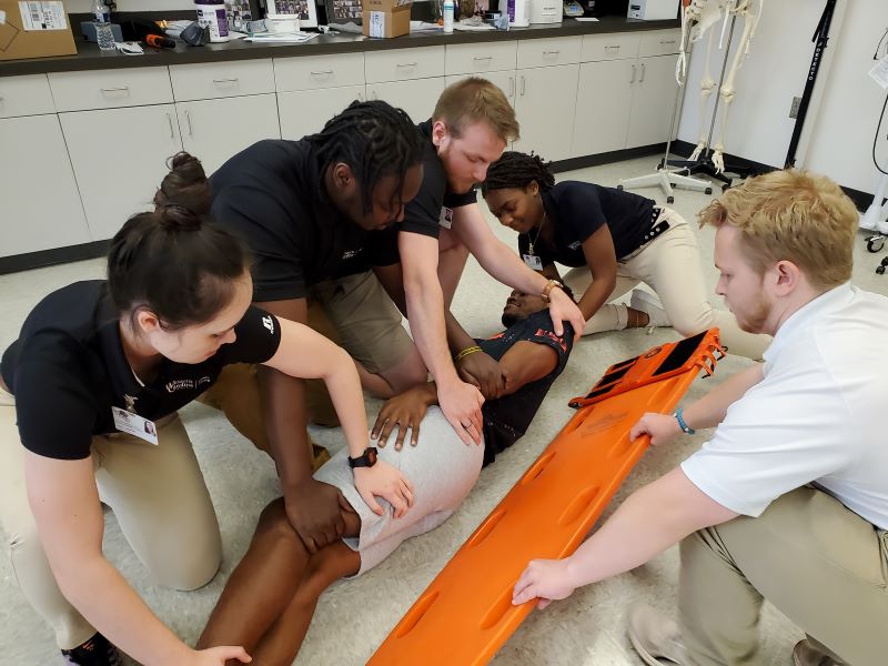 ATTR students practice moving a patient
