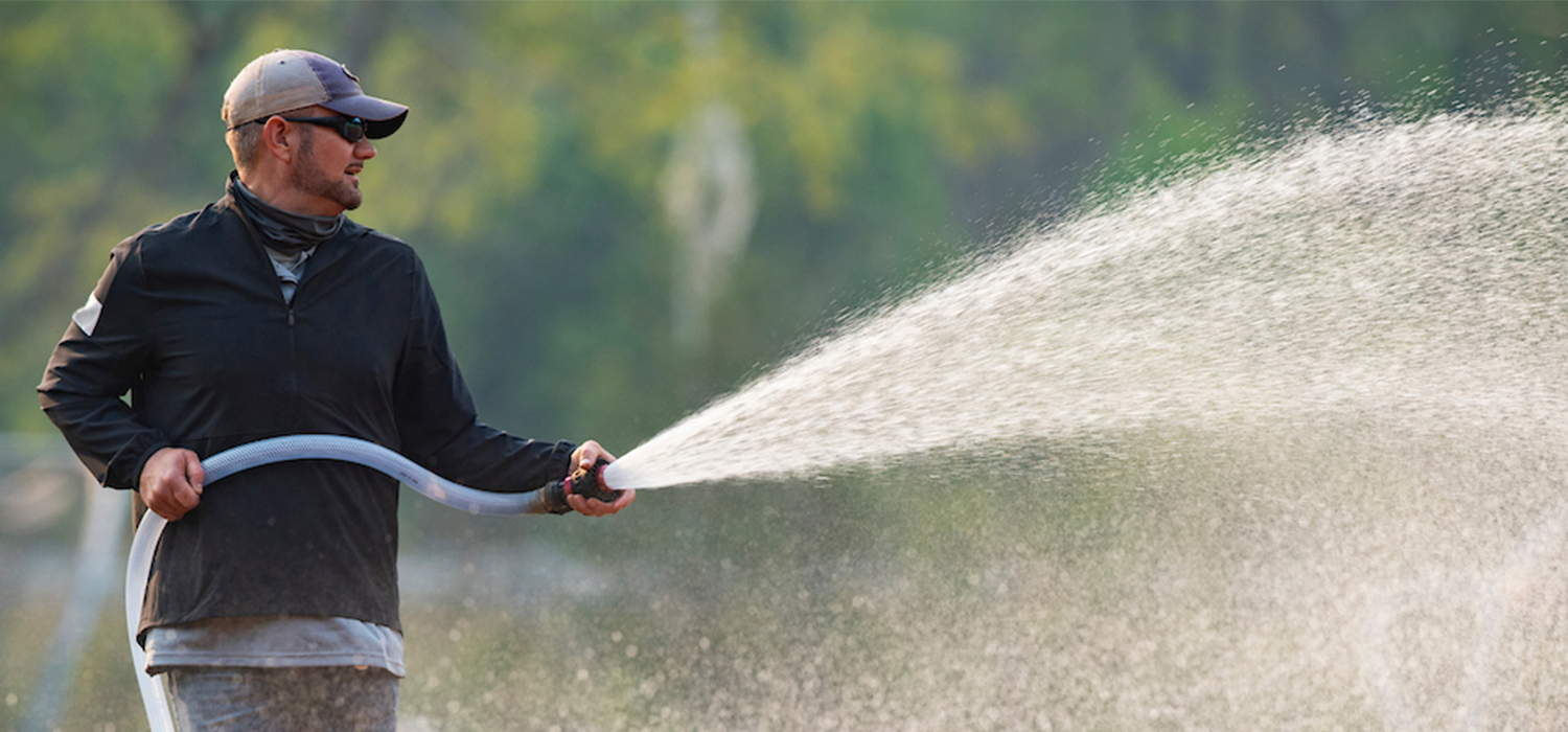 Employee watering a field