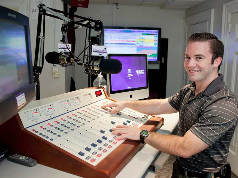 student at a radio broadcast board