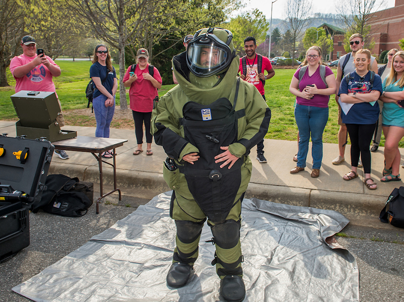 a man in a bomb suit at a demonstration