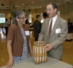 Pictured with Craft Revival project director, Anna Fariello, is Western Carolina Provost, Kyle Carter, who admires a white oak basket.