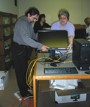 David Brose, Folklorist at the John C. Campbell Folk School sets up a new computer workstation with Jill Ellern, Hunter’s Systems Librarian.